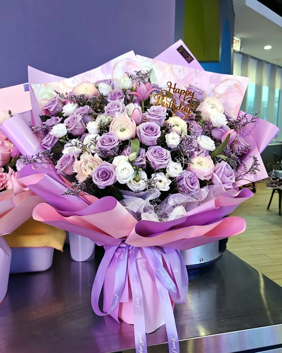 Lavender rose bouquet displayed against its original studio background