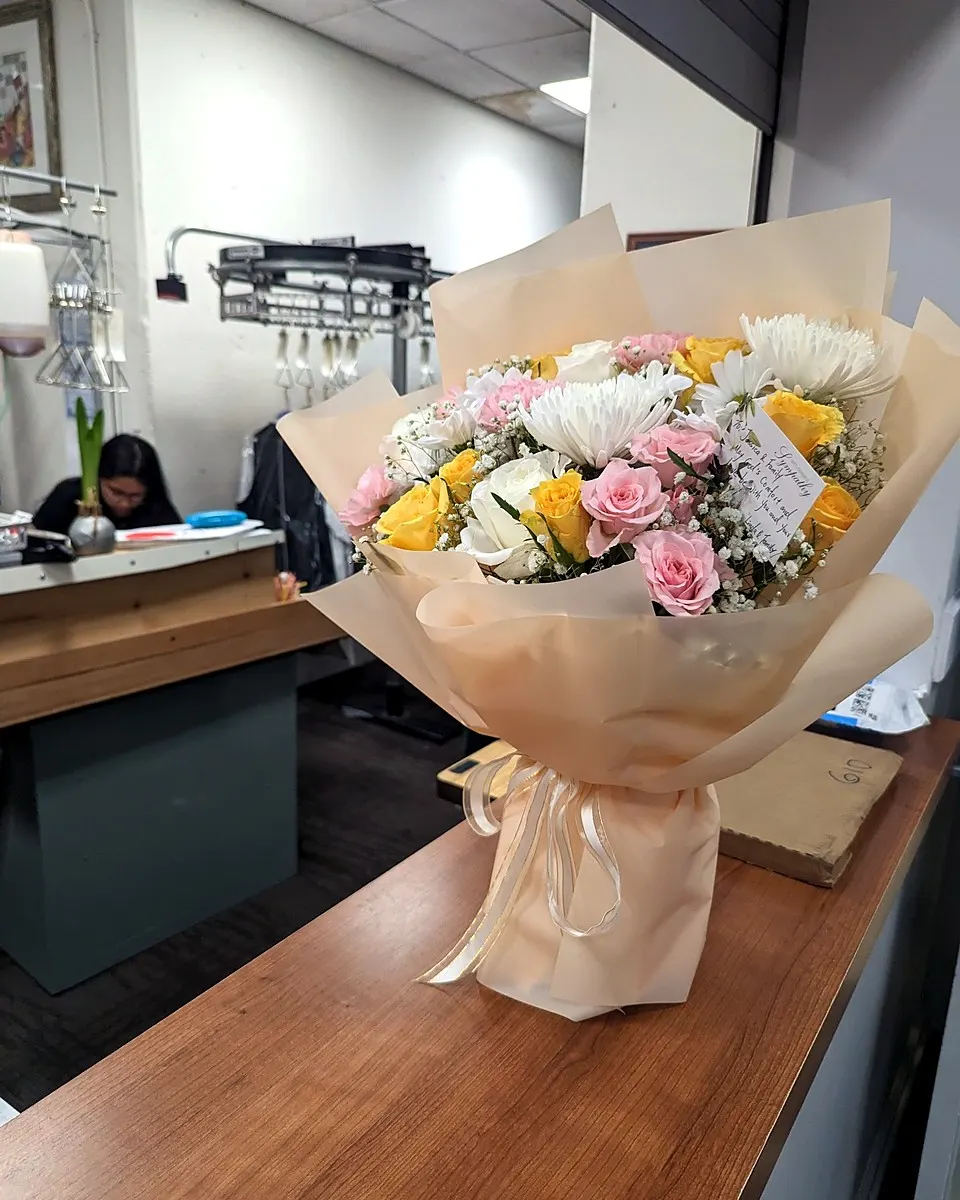 Ivory hand-tied bouquet with lilies and pale roses