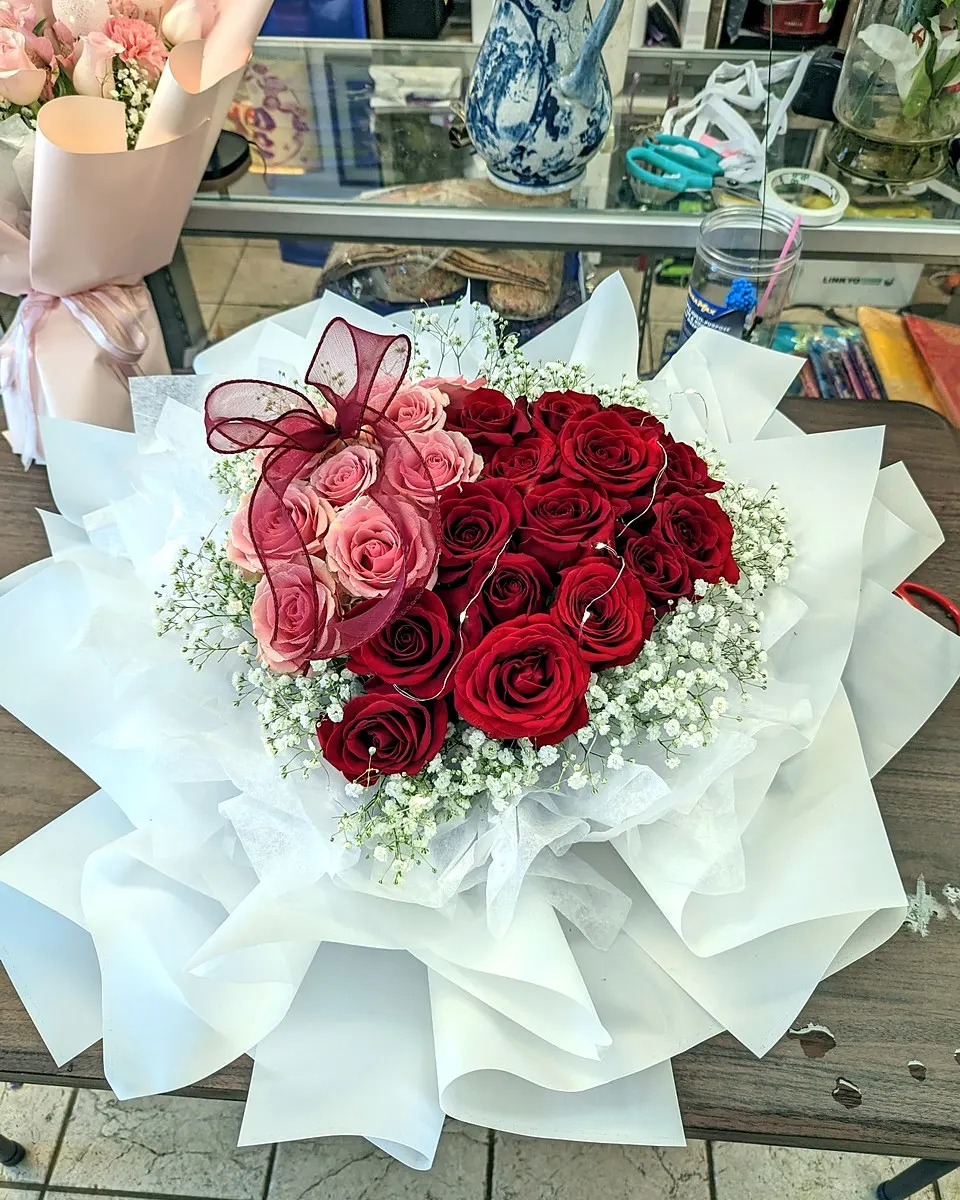 Red rose bouquet wrapped in silver gray paper