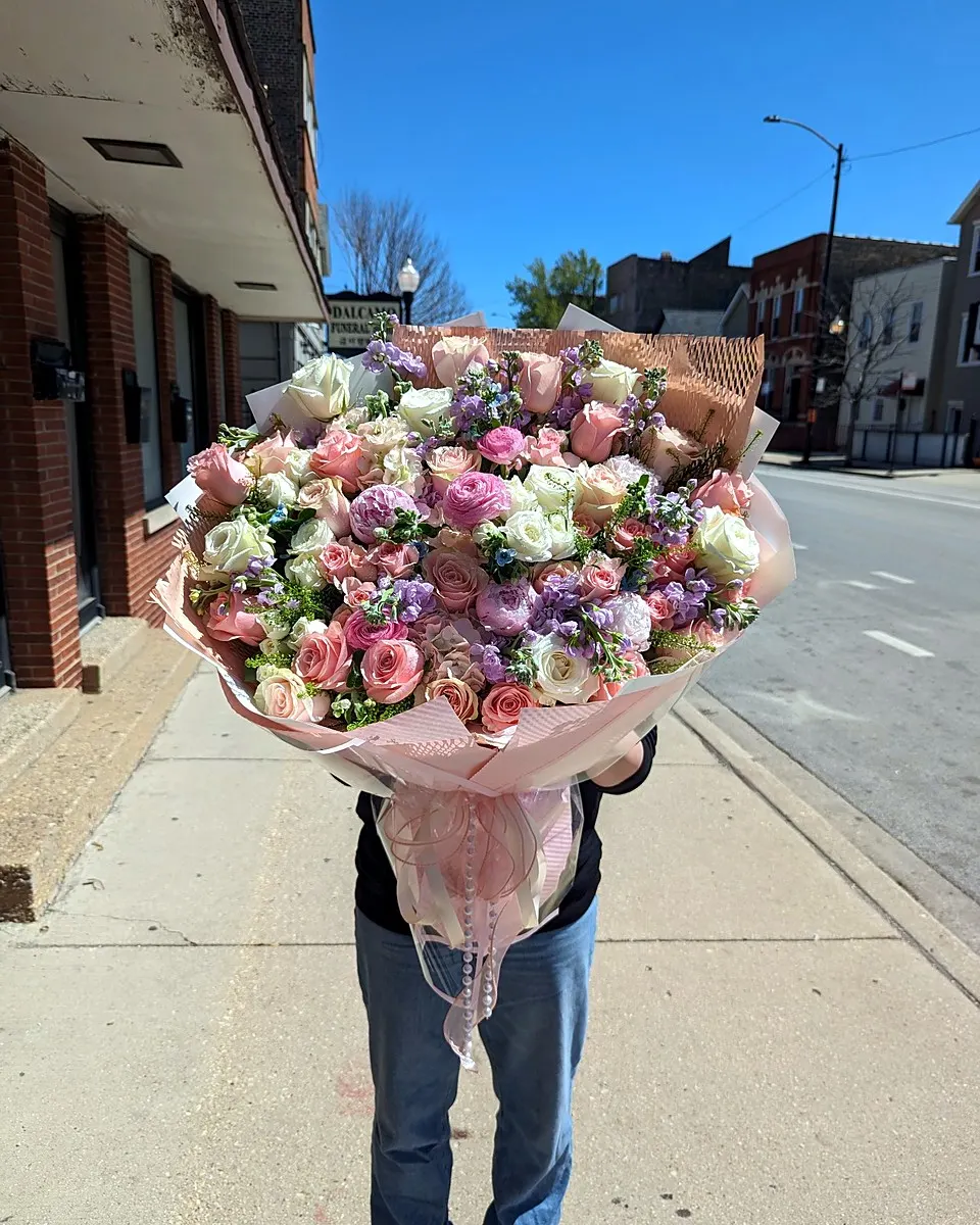 Dusty pink hand-tied bouquet carried outdoors