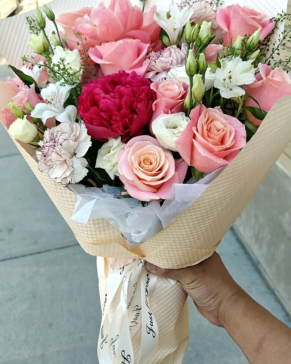White and pale pink bouquet with pearl-like decorative accents