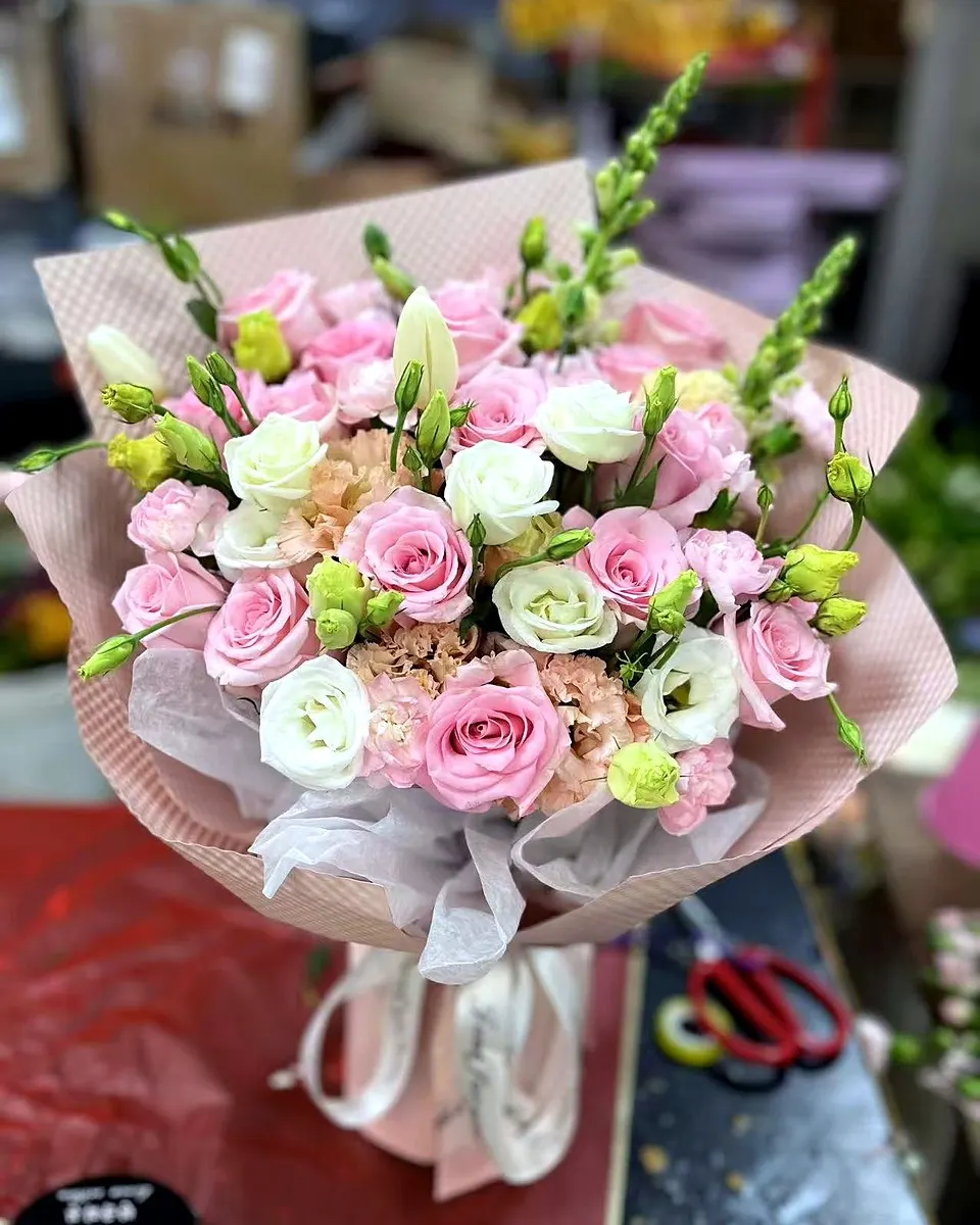 Pink rose bouquet with layered pink wrapping and ribbon