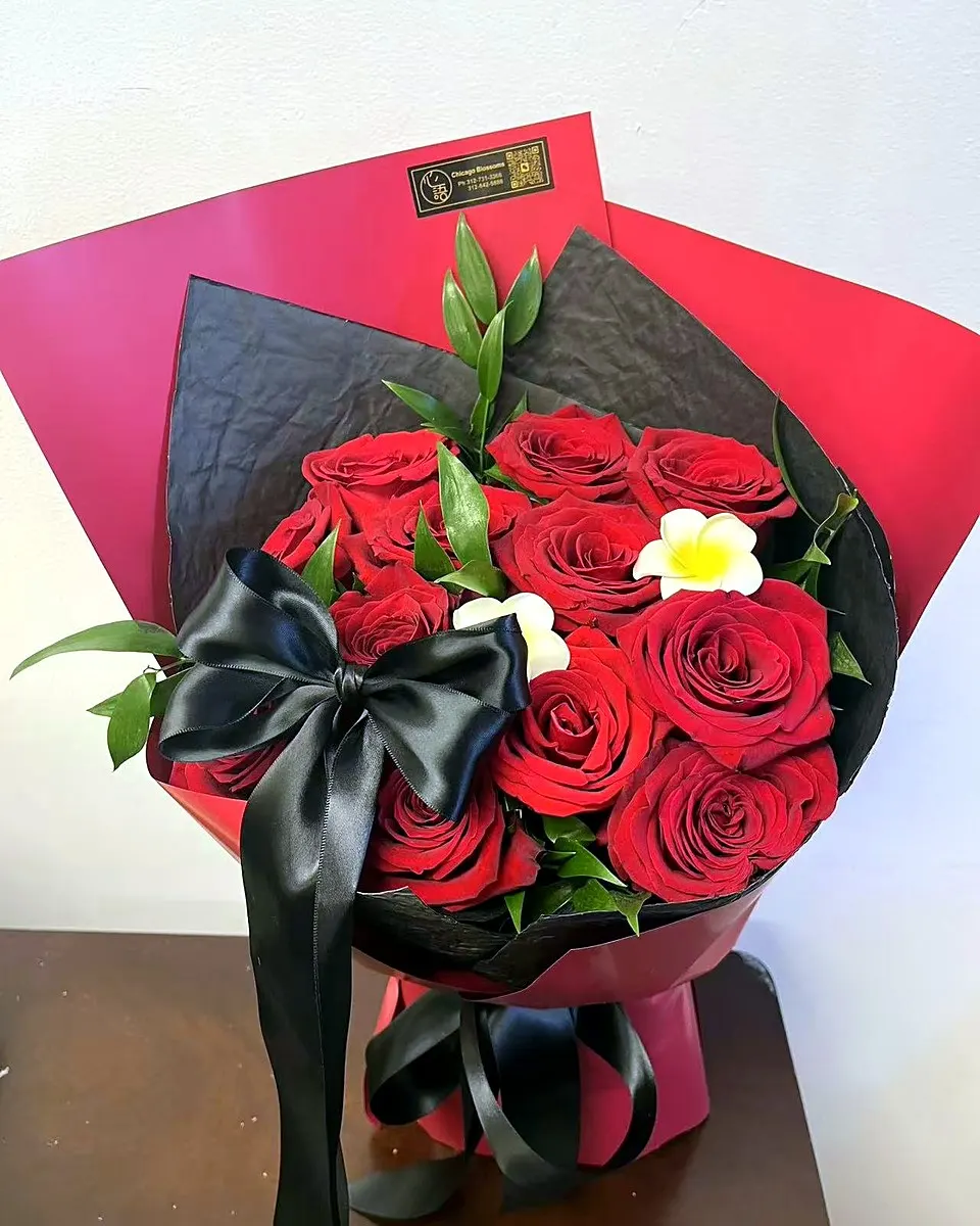 Red rose bouquet wrapped in dramatic black and red paper