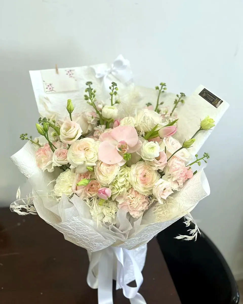 Pink and white spring bouquet with roses and delicate filler flowers
