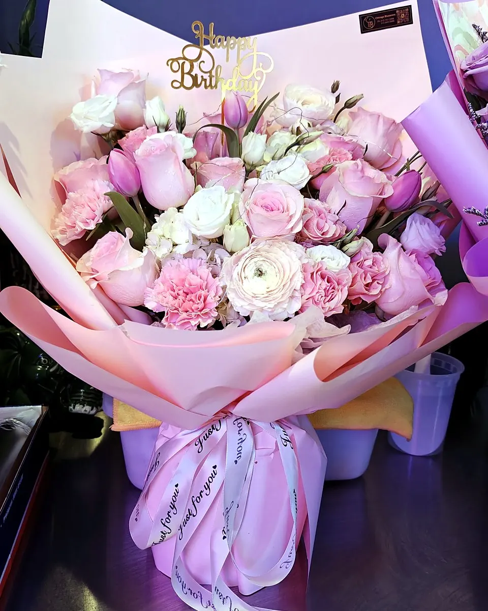 Pink birthday bouquet with roses and decorative accents