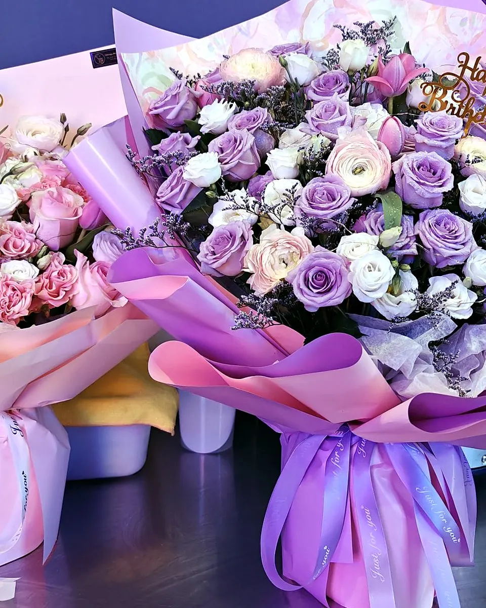 Pink and purple hand-tied bouquets displayed side by side