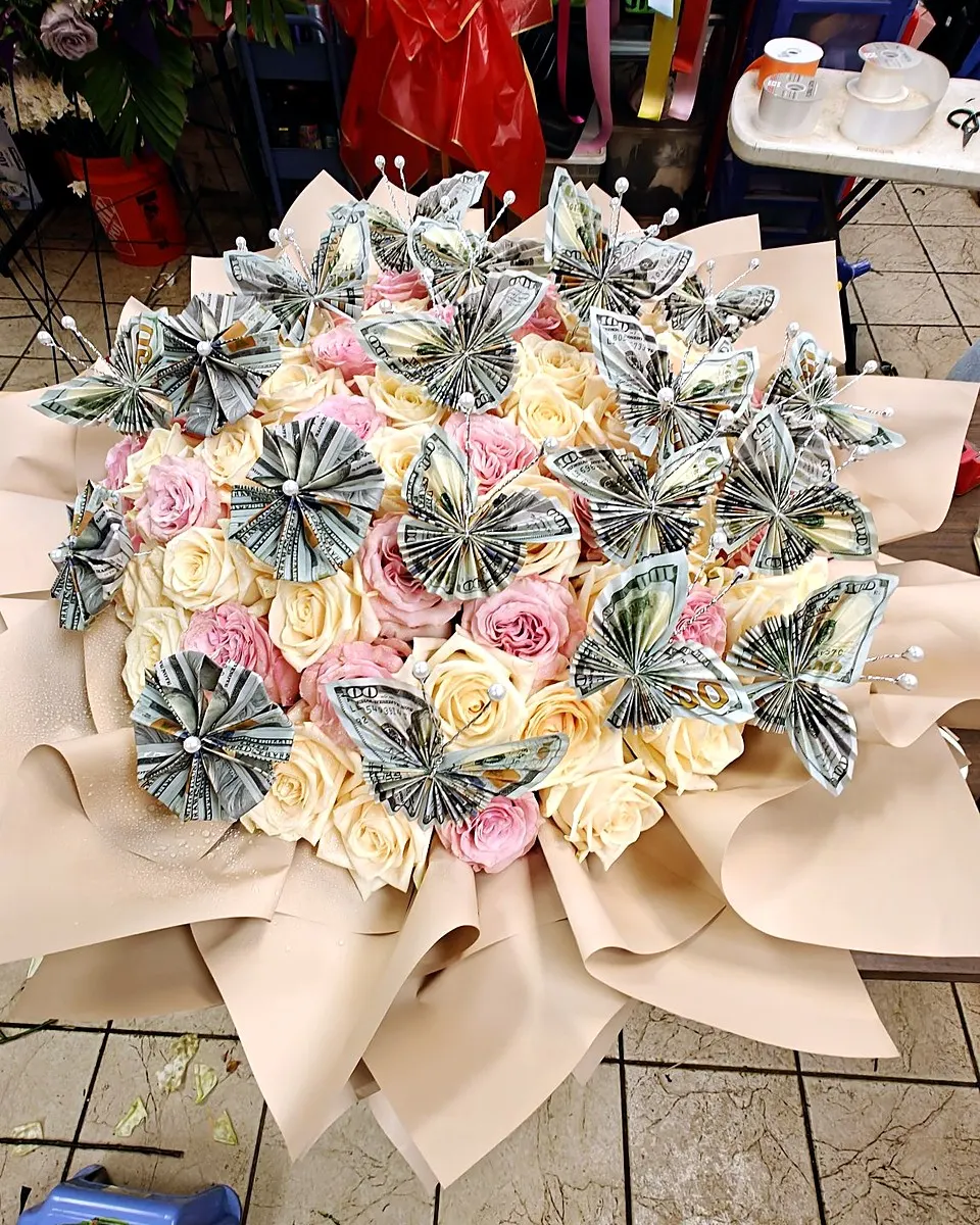 Pink and ivory rose bouquet decorated with folded money butterflies