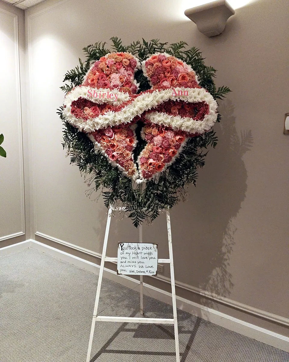Pink rose heart-shaped memorial wreath with white ribbon accents